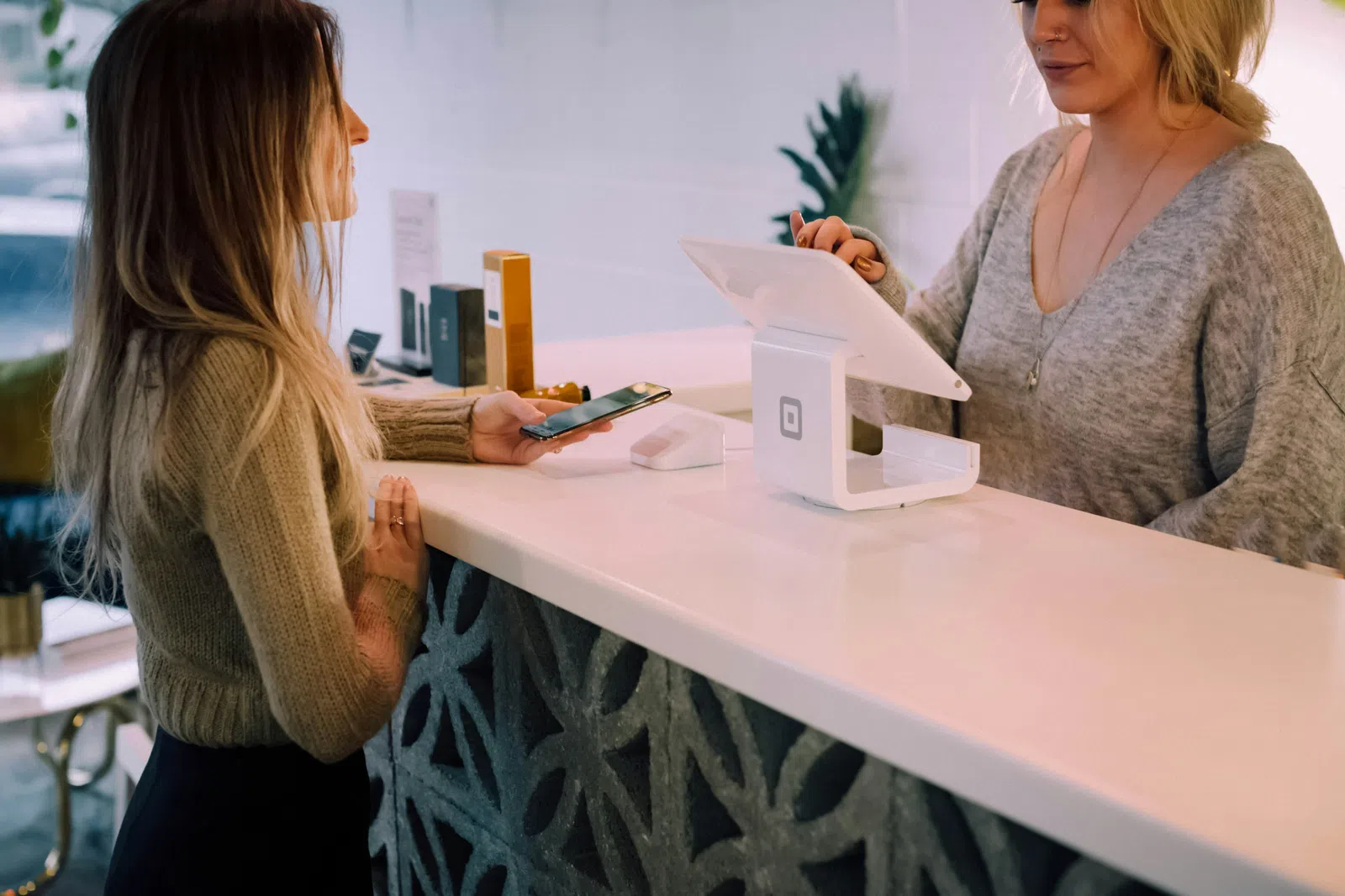a woman showing a woman something on the phone