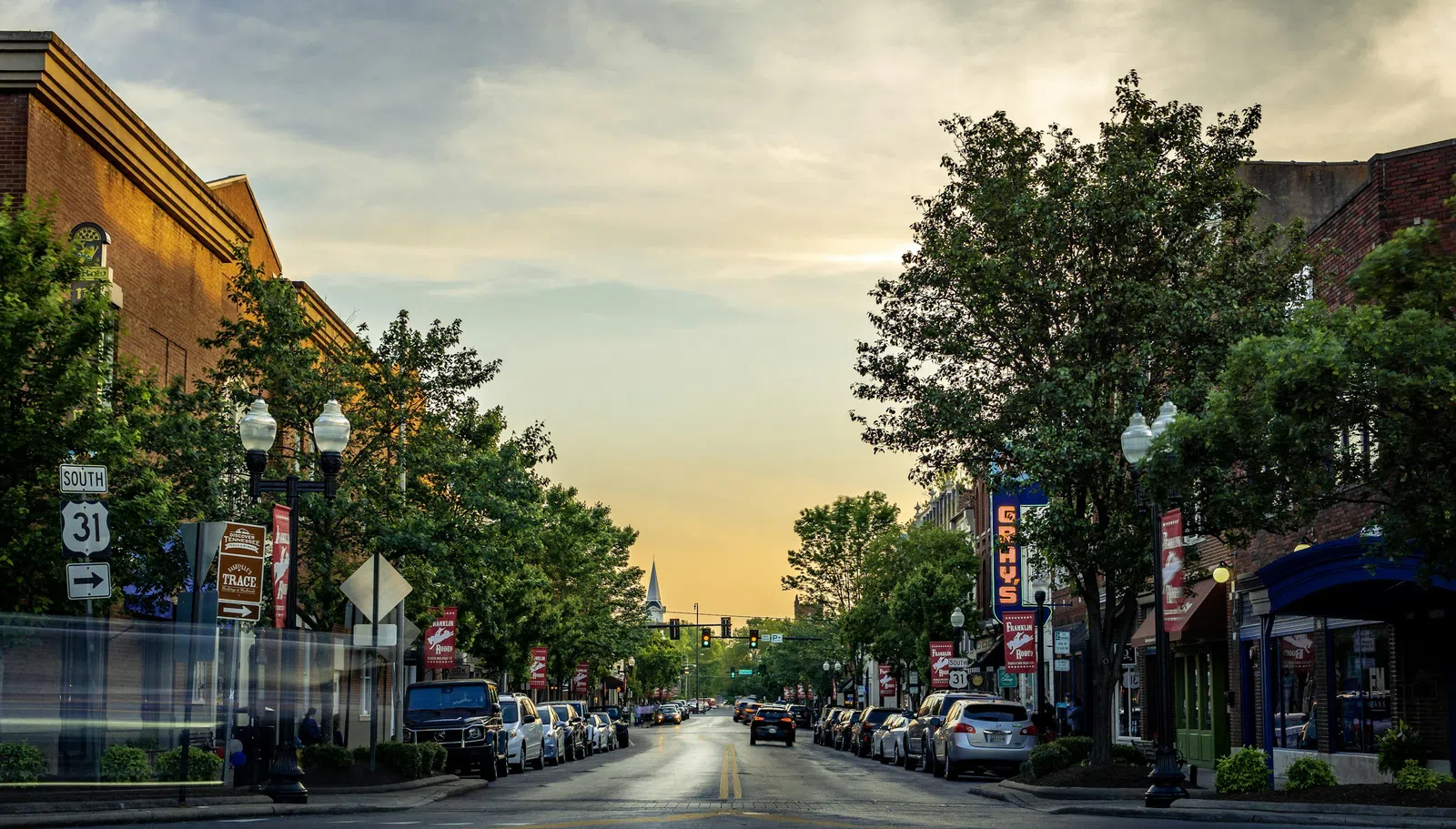 a street with cars and trees