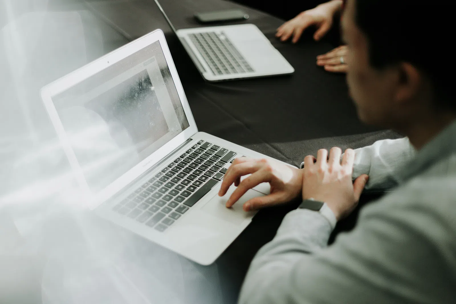a man and a woman using a laptop