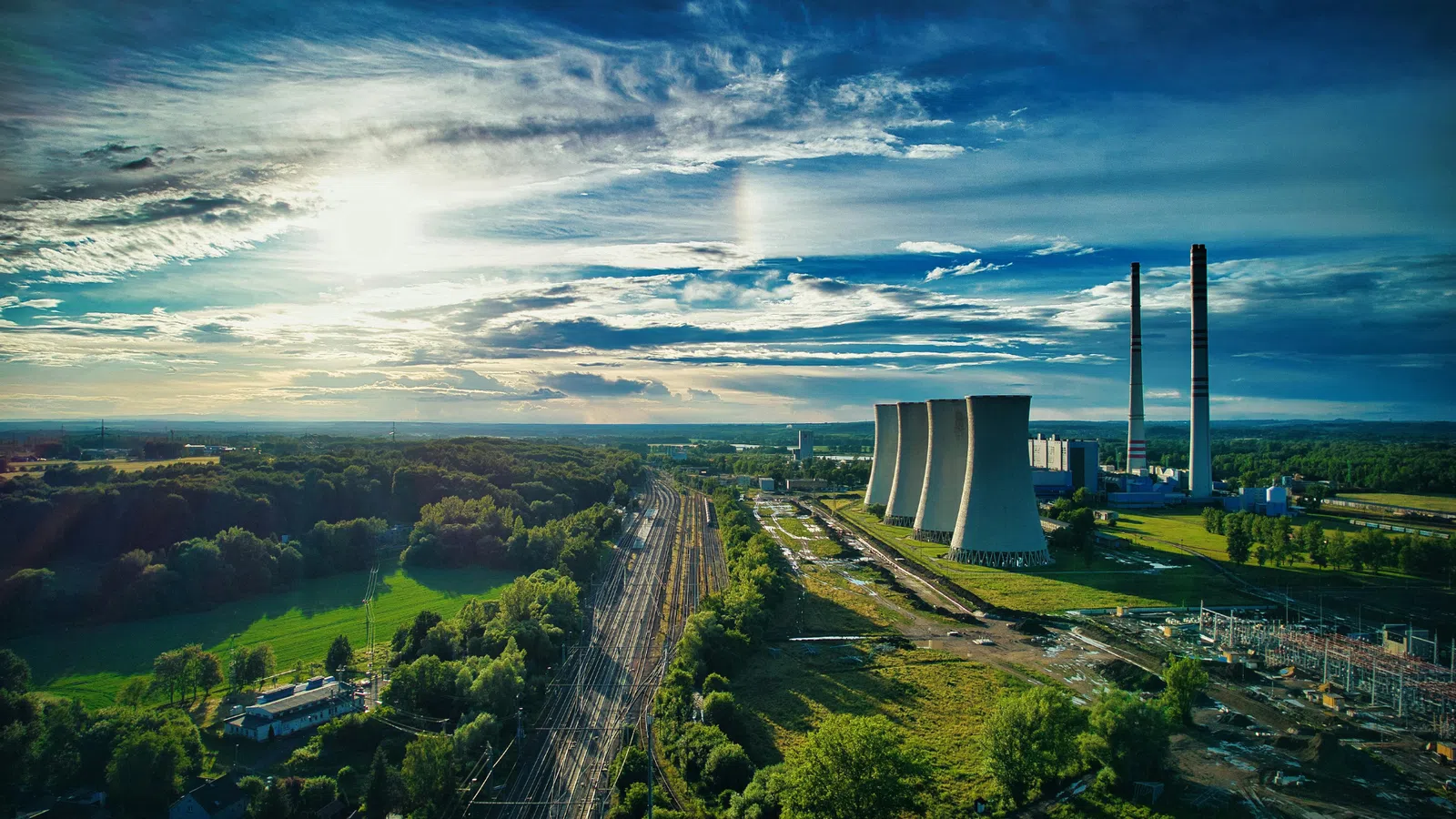 a large factory with a road and trees around it