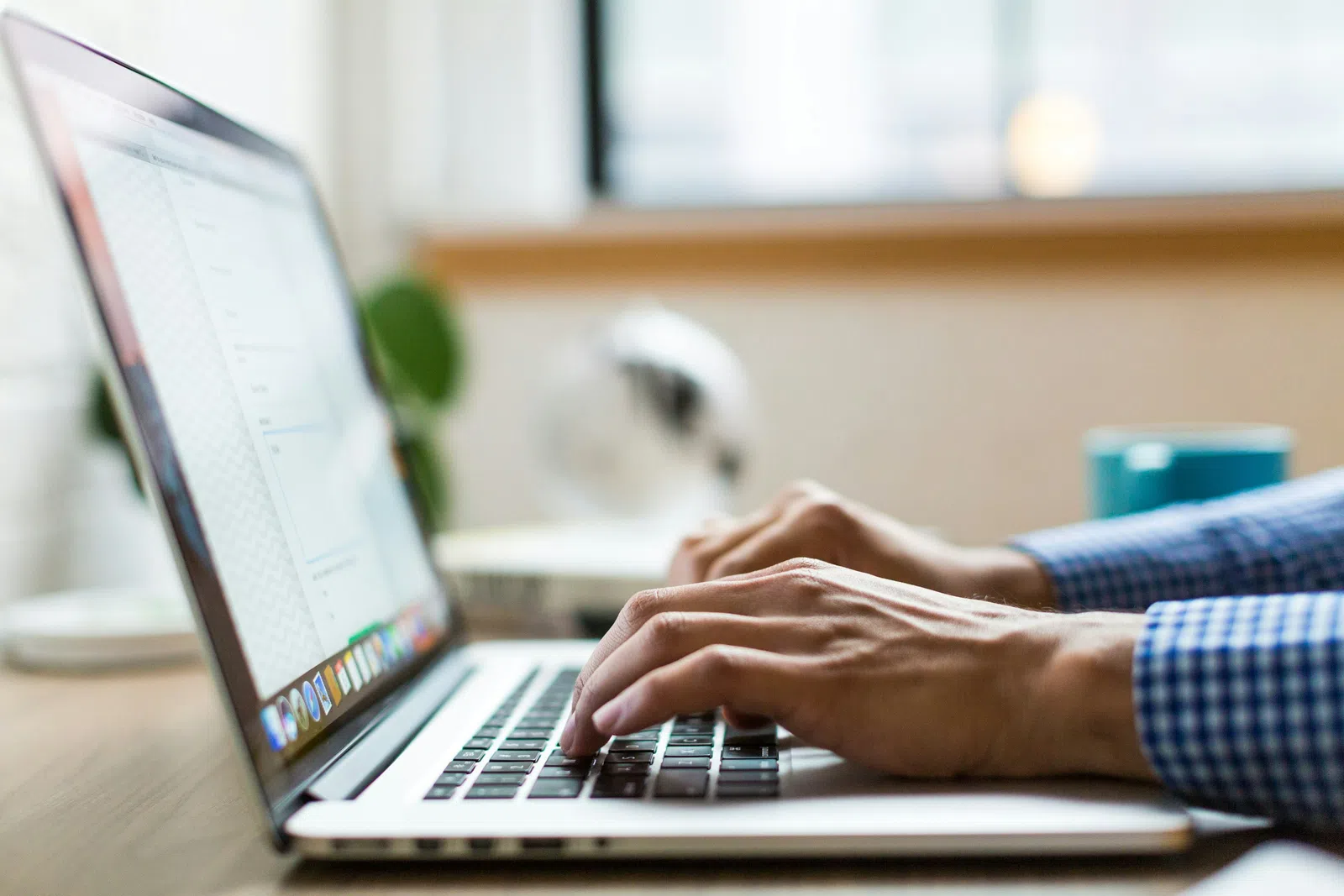 a person typing on a laptop