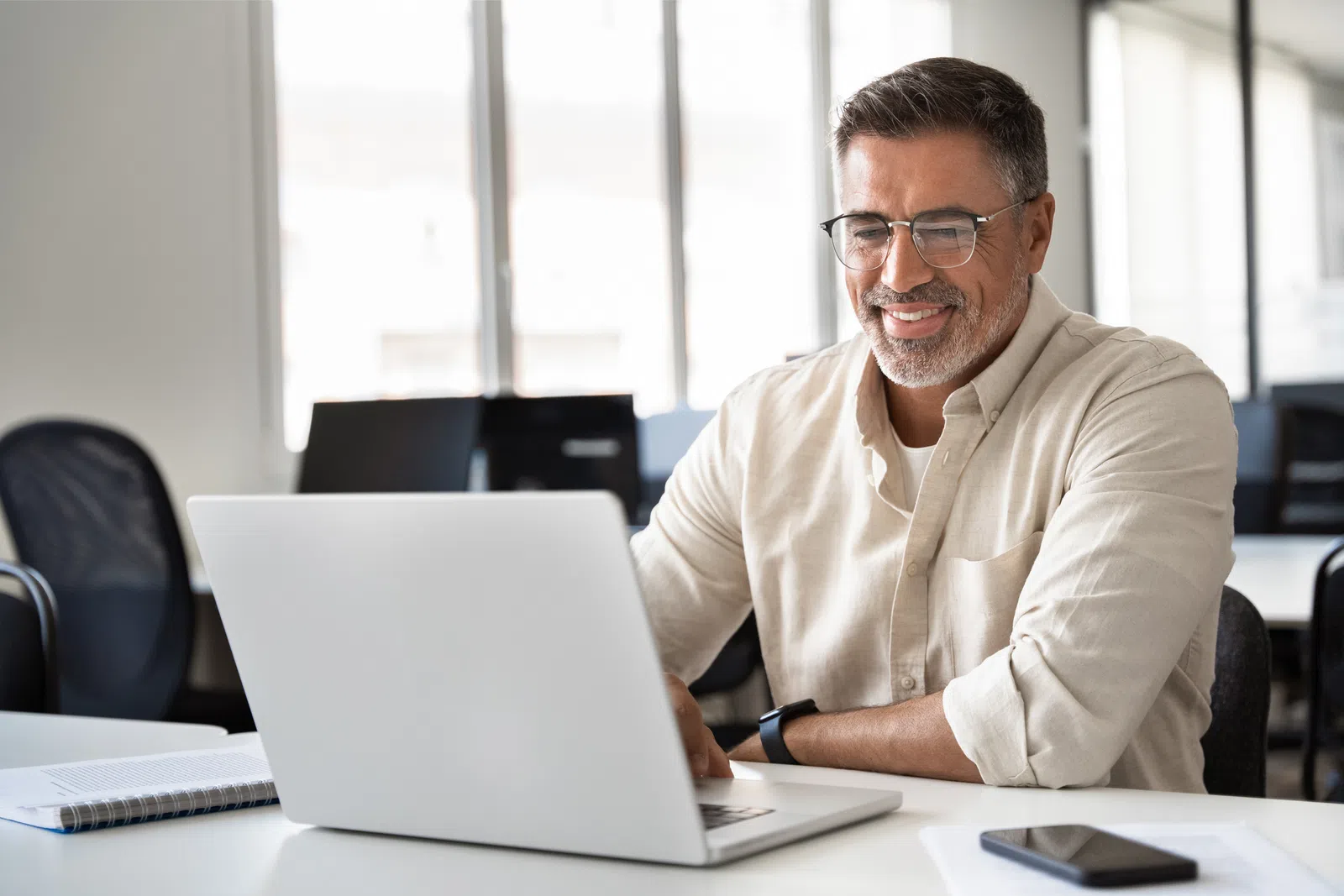 a man sitting at a table with a laptop