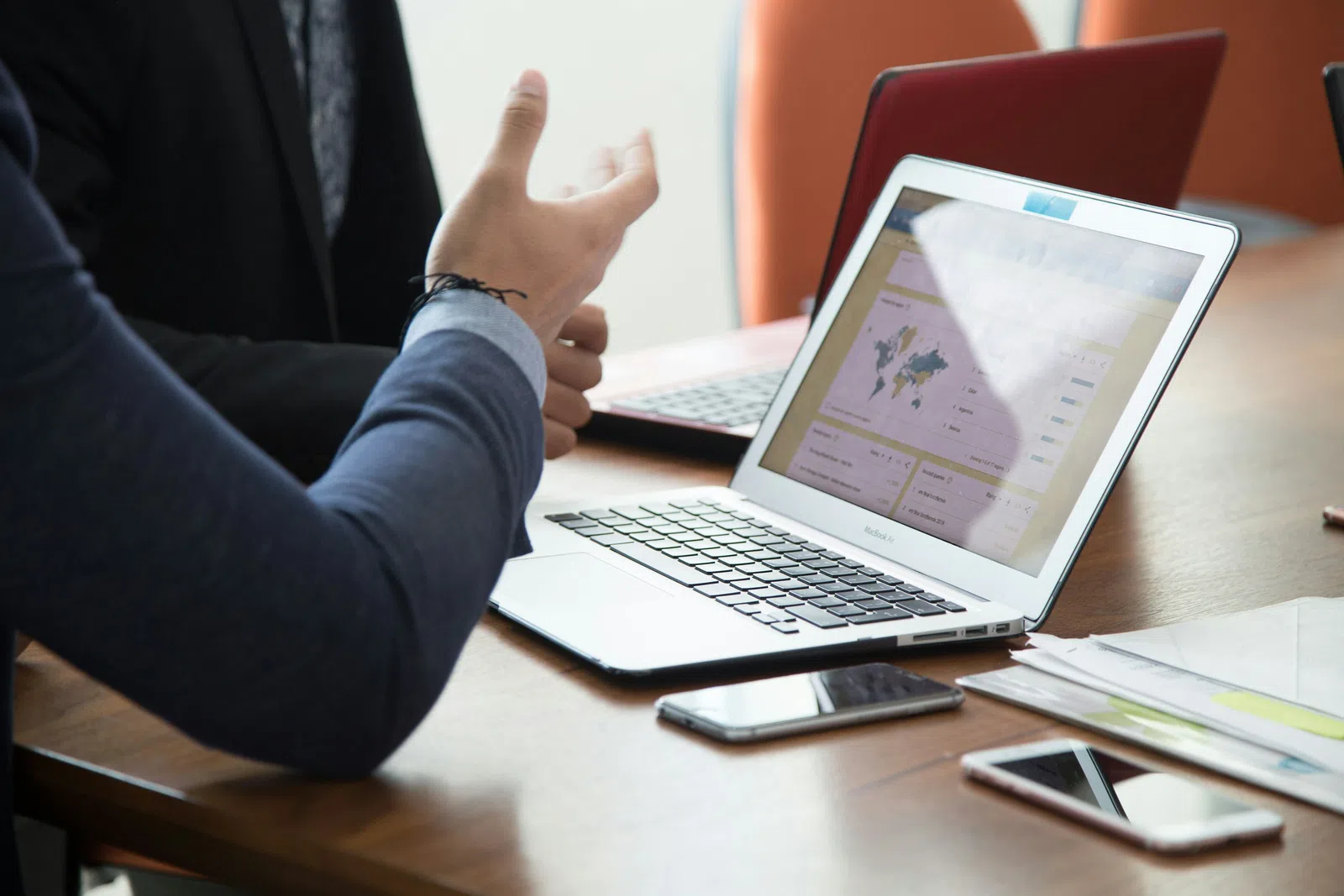 a person pointing at a laptop