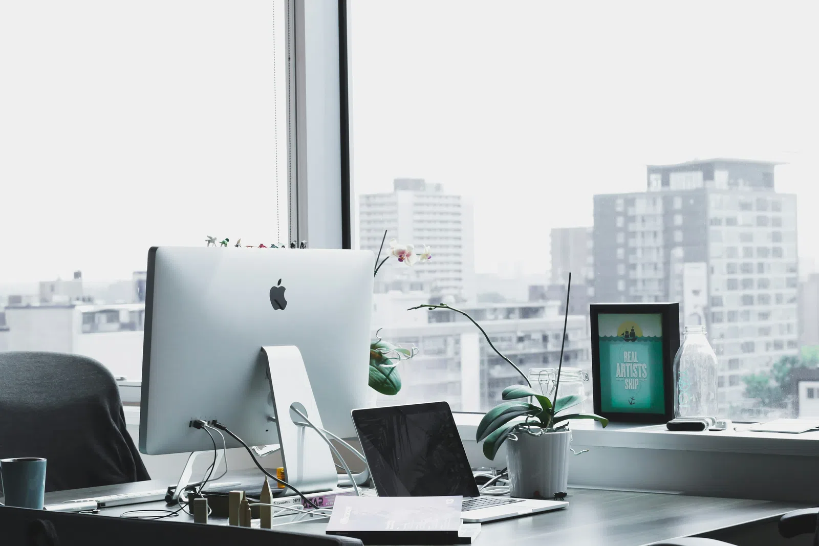 a desk with a computer and other office items