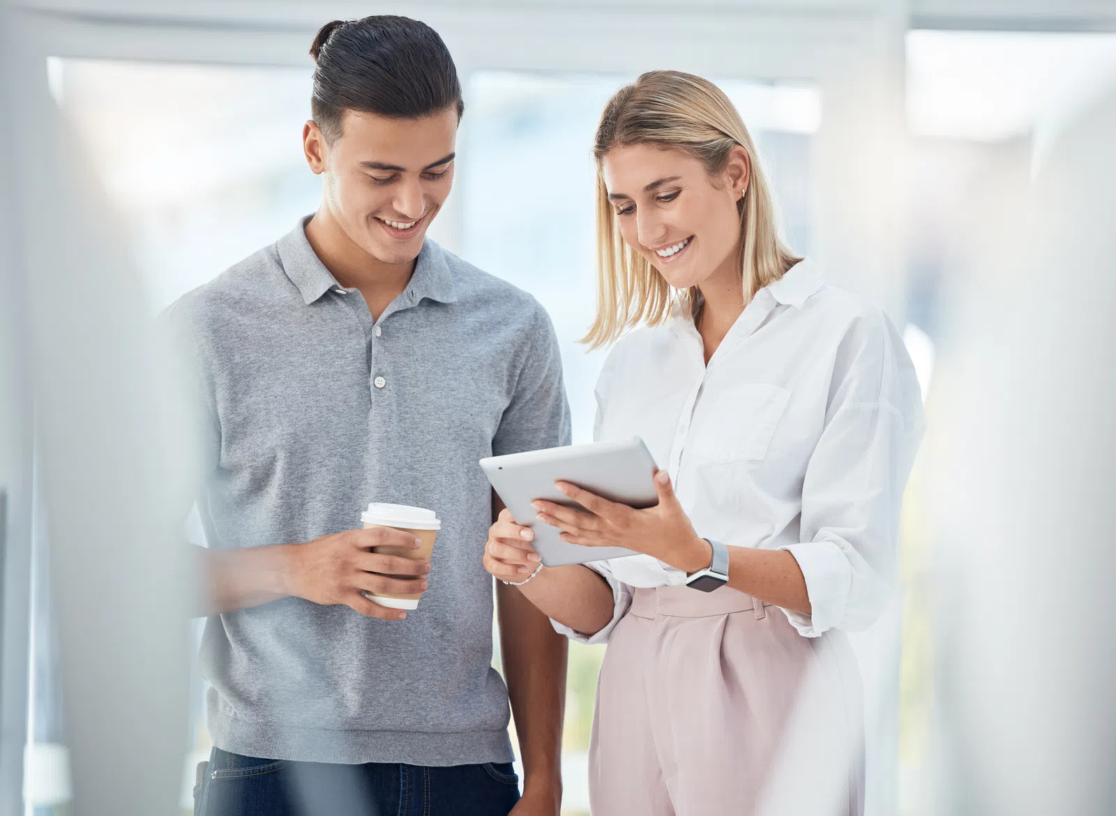 a man and a woman looking at a tablet